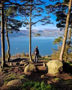 a man standing on a hill with a view of a lake at Newry Premium B&B in Newry