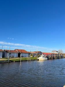 a boat is docked at a dock on the water at Charmant duplex Audenge in Audenge