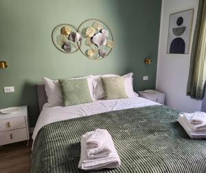 a bedroom with a bed with towels on it at Morgagni Suites in Bologna
