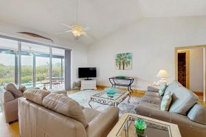 a living room with two couches and a tv at Waterfront Oasis in Englewood