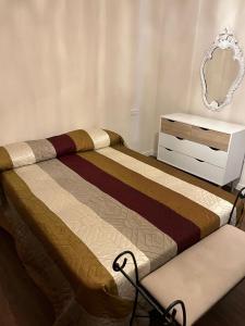 a bedroom with two beds and a dresser and a mirror at Villa Al Mar in Caleta de Interián