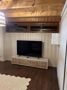 a living room with a large flat screen tv at Villa Al Mar in Caleta de Interián
