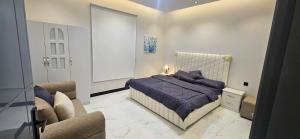 a bedroom with a bed and a couch at Summo bilding in Jeddah