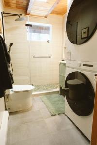 a bathroom with a toilet and a sink and a shower at Cozy Cabin near Lake Placid, Whiteface-King, Ice Barrel, Hot Tub in Jay +105 photos