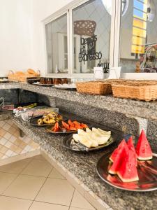 a buffet with plates of food on a counter at Hotel Laura Vicunha in Corumbá