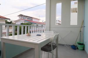 a white table and chairs on a balcony at Ilaria Bayahibe By Mireya in Bayahibe