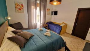 a bedroom with a blue bed with two stuffed animals on it at Rooms hub Portarotese in Salerno +12 photos