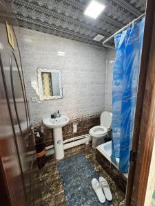 a bathroom with a sink and a toilet at Abdurauf in Bukhara