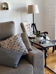 a living room with a couch and a table at Alma Da Vila in Ponte de Lima