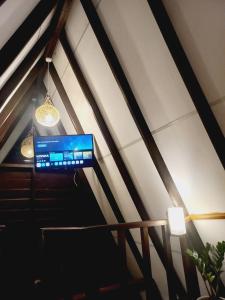 a flat screen tv hanging from a ceiling at THE JUNGLE CABIN ella in Ella