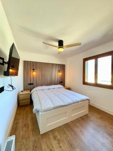 a bedroom with a bed and a ceiling fan at Oleza garden in Playa Flamenca