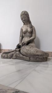 a statue of a woman sitting on a pillow at Casa de la Sirena in Baena