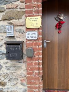 a door to a building with a sign next to it at LA SACRESTIA in Mapello +34 photos