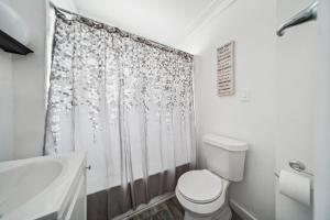 a bathroom with a toilet and a shower curtain at 3 bedroom 1 bath in Cleveland in Cleveland +20 photos