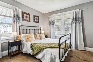 a bedroom with a bed and two windows at 3 bedroom 1 bath in Cleveland in Cleveland