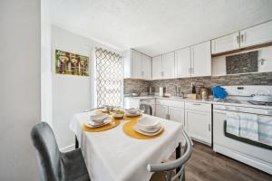 a white kitchen with a table and chairs in it at 3 bedroom 1 bath in Cleveland in Cleveland