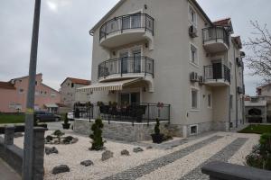 a large white building with balconies on it at Apartments Lavendula in Vodice
