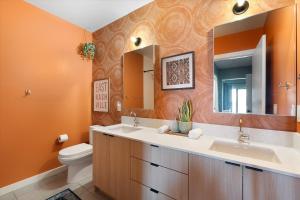 a bathroom with a sink and a toilet and a mirror at Hyve in Nashville +195 photos