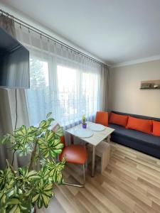 a living room with a table and a couch at Mieszkanie przy Parku in Sandomierz