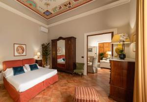 a bedroom with a bed and a living room at Palazzo Alfani - Residenza d'Epoca in Florence