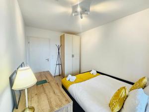 a bedroom with two beds and a table and a lamp at Stunning 2 bedrooms with private terrace in Luxembourg in Luxembourg