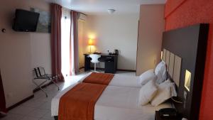 מיטה או מיטות בחדר ב-Central Hotel Cayenne