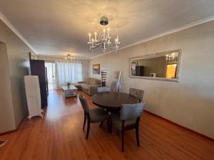 a living room with a table and chairs and a couch at 2 Bedroom City Center Haven! in Swakopmund