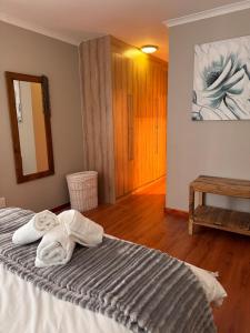 a bedroom with a bed with towels on it at 2 Bedroom City Center Haven! in Swakopmund