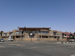 an empty parking lot in front of a building at 2 Bedroom City Center Haven! in Swakopmund