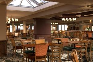 a dining room with tables and chairs in a restaurant at Riverside 24 - Haggerston Castle in Berwick-Upon-Tweed