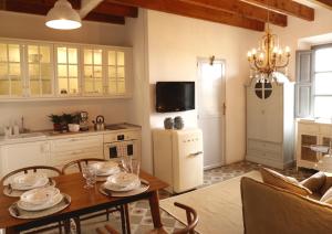 a kitchen with a dining table and a refrigerator at Villa Station by Cassai in Ses Salines