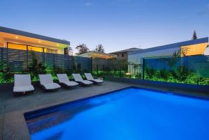 a swimming pool in front of a house at Cavvanbah - April Sun Villa in Byron Bay +13 photos