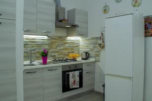 a kitchen with a sink and a stove top oven at Tourist House Palermo in Palermo +32 photos