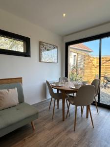 a dining room with a table and chairs at La Cabane in Quiberville