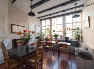 a dining room and living room with a table and chairs at De Kaepstander in Middelburg