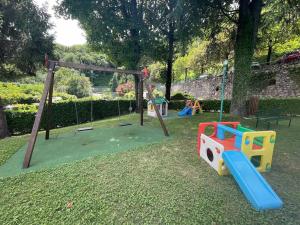 a childrens playground with a play set and a swing at Residence sul Lago di Como vicino Bellagio in Valbrona