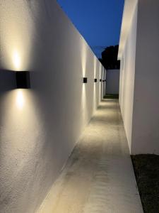 a hallway with lights on the side of a building at Heyday Studio With Full Kitchenette in Santiago de los Caballeros
