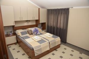a bedroom with a bed with two towels on it at Apartments Lavendula in Vodice