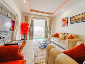 a living room with a couch and a table at Serene Sea View One Bedroom Apt Shanzu in Mombasa