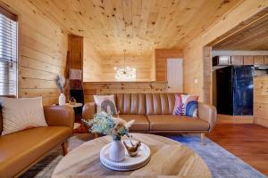 a living room with a couch and a table at Modern 6BR Cabin- Hot Tub Theater Basketball in White Haven