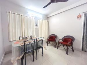 a dining room with a table and chairs at Sarita's Homestay in Durgāpur