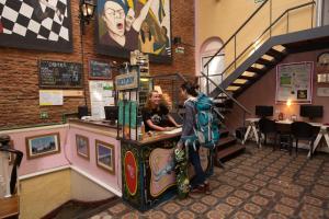 a man and a woman standing at a counter in a store at BA STOP Hostel in Buenos Aires