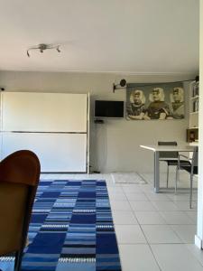 a kitchen with a refrigerator and a table with chairs at Goudkust in Vlissingen +2 photos