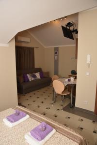 a living room with a couch and a table with purple towels at Apartments Lavendula in Vodice