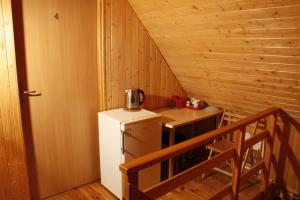 a small kitchen with a refrigerator and a table at The Jolly Man in Vilnius
