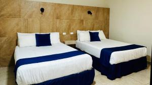Postel nebo postele na pokoji v ubytování Hotel Jazuli