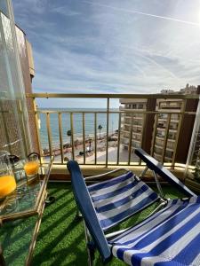 a balcony with a table and chairs and the beach at Fuengirola, Doña Sofia amazing sea view in Fuengirola