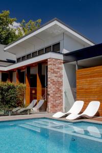 a house with a swimming pool in front of a house at Norwood Haven- Pool - Pet Friendly & Free WiFi in Norwood