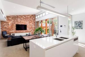 a kitchen and living room with a brick wall at Norwood Haven- Pool - Pet Friendly & Free WiFi in Norwood