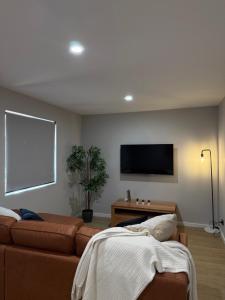 a living room with a couch and a flat screen tv at Coober Pedy Apartments in Coober Pedy